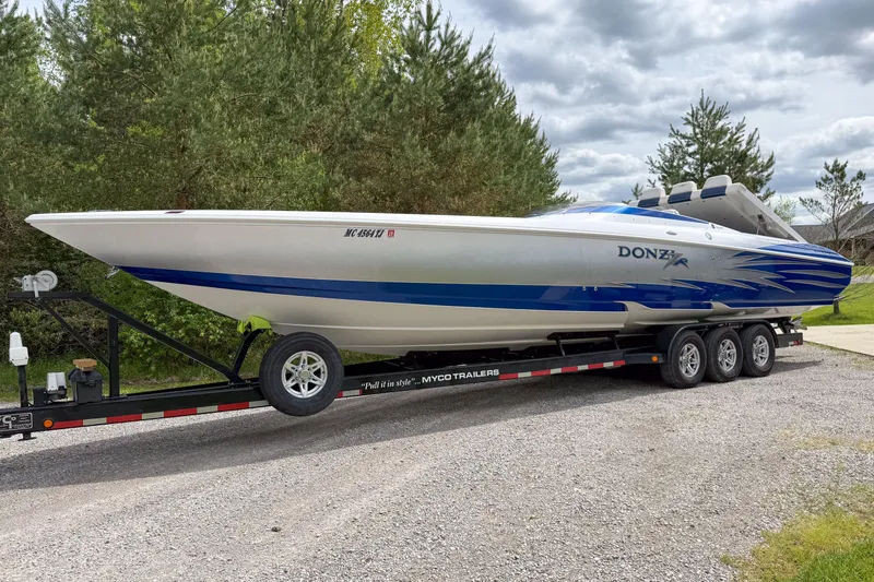 Slide: The Image of 2005 Donzi 38 ZR speedboat on trailer, parked on gravel road. - 6