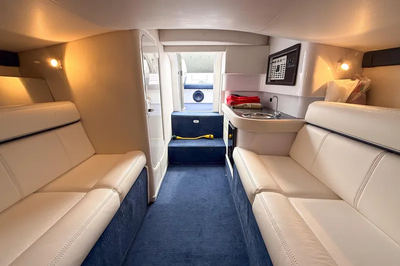 Slide: The Image of Interior of 2005 Donzi 38 ZR boat with plush seating and compact kitchenette. - 7