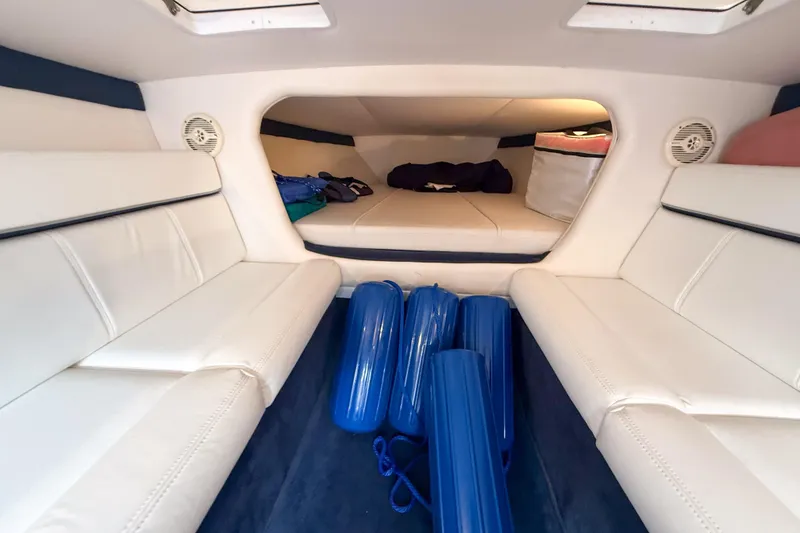 Slide: The Image of Interior of 2005 Donzi 38 ZR boat with white seating and blue fenders. - 8
