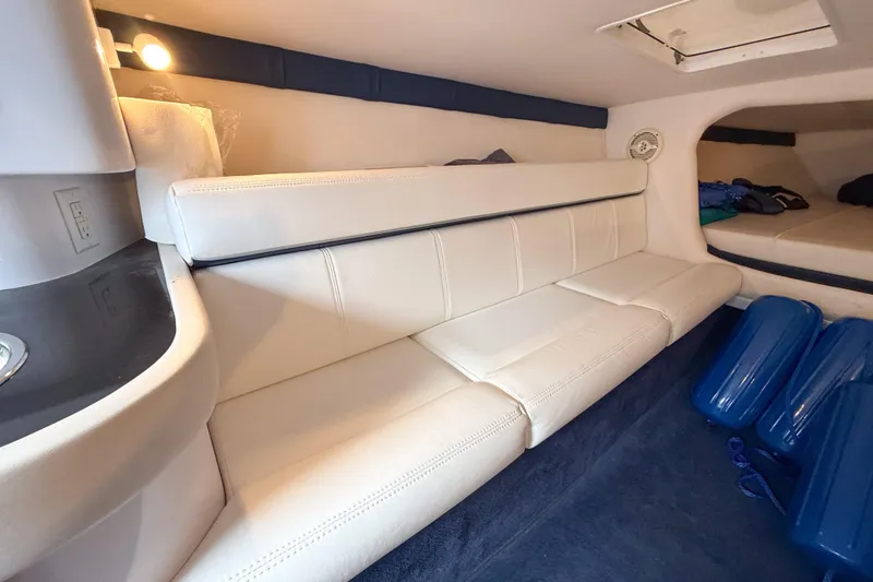 Slide: The Image of Interior of a 2005 Donzi 38 ZR boat with white seating and blue accents. - 9