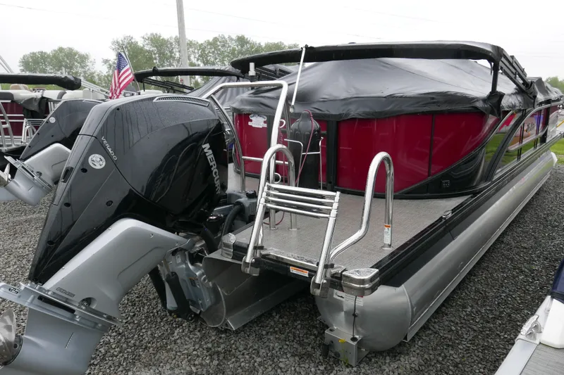 Slide: The Image of 2022 Barletta CORSA 23QC pontoon boat with Mercury outboard engine, covered and docked. - 15