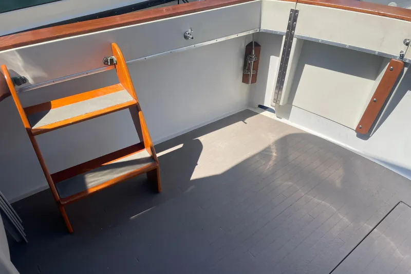 Slide: The Image of 1974 Tollycraft 37 Sedan boat interior with wooden ladder and clean deck. - 11