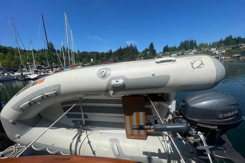 Slide: The Image of 1974 Tollycraft 37 Sedan with inflatable dinghy and Yamaha motor at marina. - 13