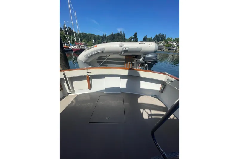 Slide: The Image of 1974 Tollycraft 37 Sedan boat deck with inflatable dinghy in marina setting. - 14