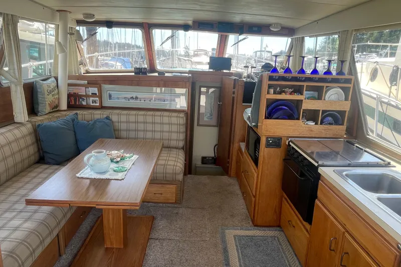 Slide: The Image of Interior of a 1974 Tollycraft 37 Sedan yacht with cozy seating and kitchen area. - 15