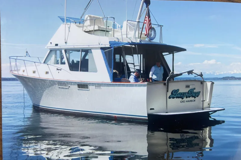 Slide: The Image of 1974 Tollycraft 37 Sedan boat on calm water, featuring "Lazy Days" from Gig Harbor. - 2