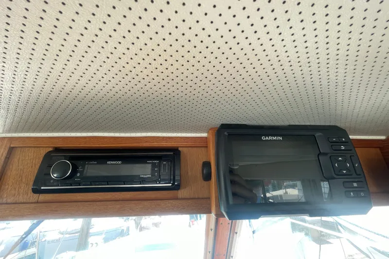 Slide: The Image of Kenwood stereo and Garmin device on 1974 Tollycraft 37 Sedan boat interior. - 25
