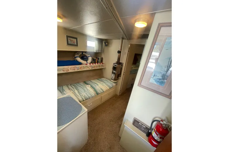 Slide: The Image of 1974 Tollycraft 37 Sedan interior with cozy bunk beds and nautical decor. - 30