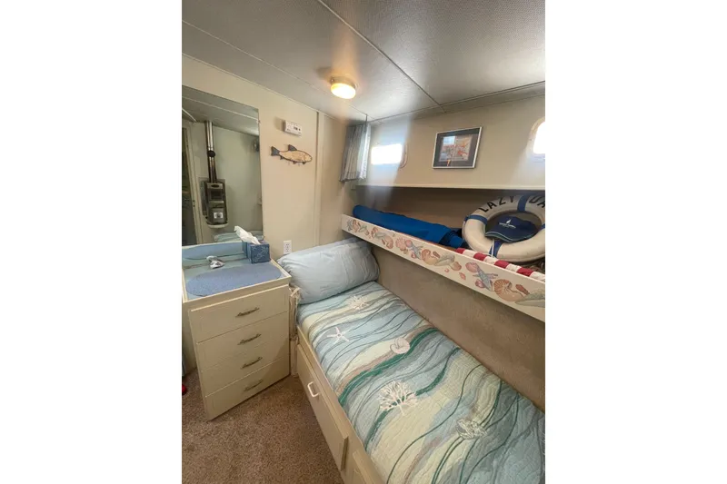 Slide: The Image of Cozy cabin interior of 1974 Tollycraft 37 Sedan with nautical decor and bedding. - 31