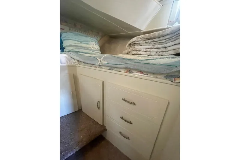Slide: The Image of 1974 Tollycraft 37 Sedan interior with bedding and storage drawers. - 33