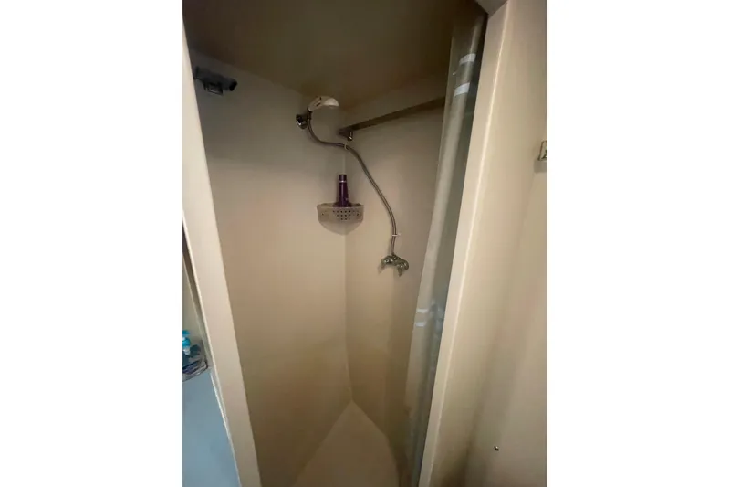 Slide: The Image of Shower area inside a 1974 Tollycraft 37 Sedan boat, featuring a compact design. - 39