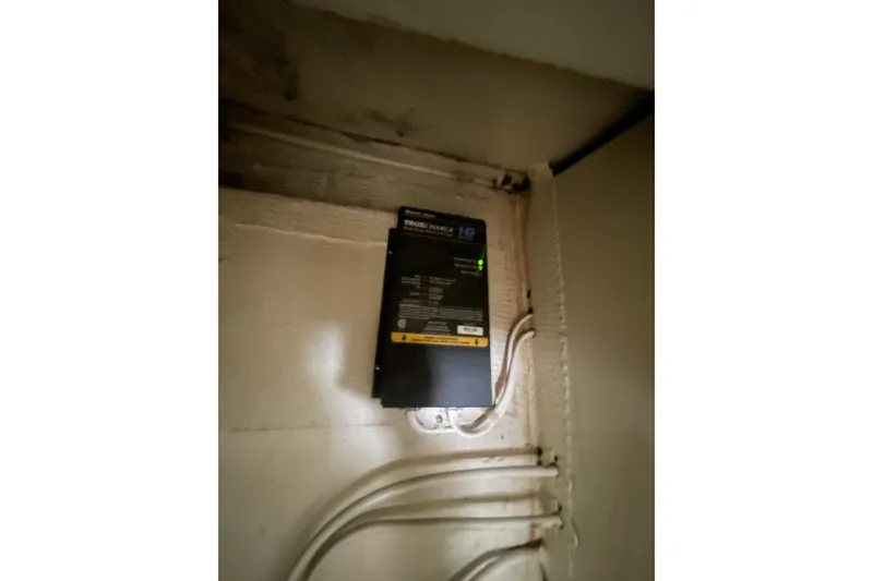 Slide: The Image of Electrical panel inside a 1974 Tollycraft 37 Sedan boat, featuring wiring and a control box. - 42