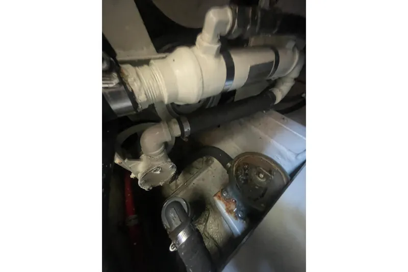 Slide: The Image of Engine compartment of a 1974 Tollycraft 37 Sedan, showcasing pipes and mechanical components. - 49