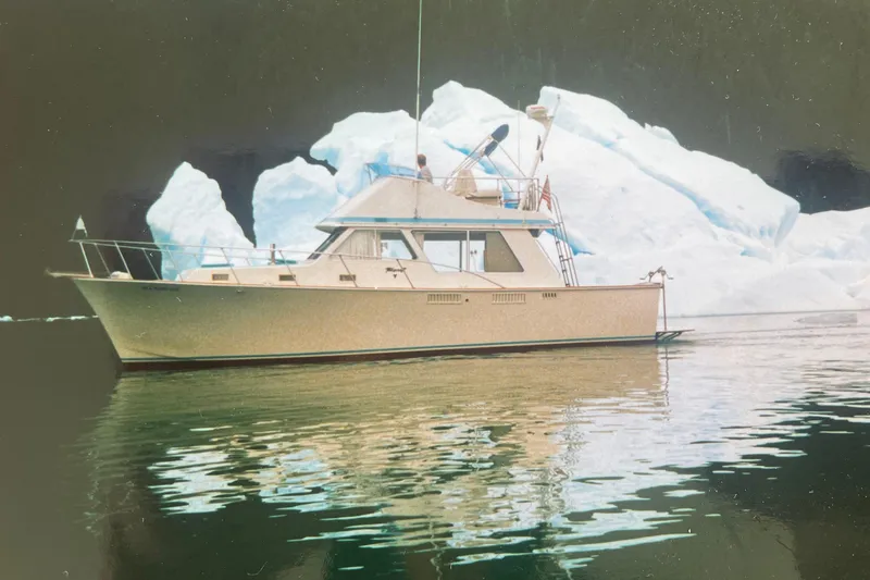 Slide: The Image of 1974 Tollycraft 37 Sedan yacht cruising near icebergs on calm waters. - 52