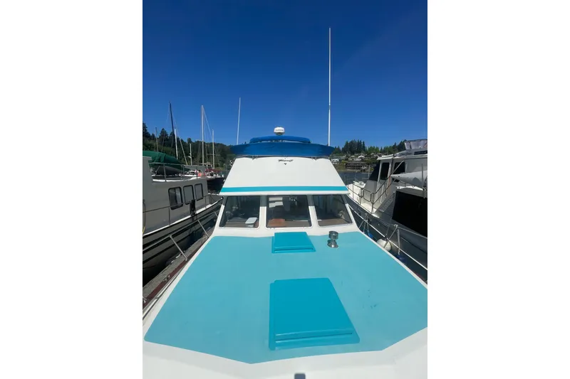 Slide: The Image of 1974 Tollycraft 37 Sedan boat docked under clear blue sky. - 8
