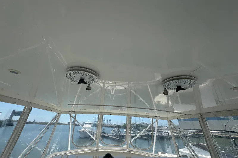 Slide: The Image of Interior view of a 1997 Bertram 54 Convertible yacht with marina backdrop. - 13