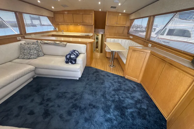 Slide: The Image of Luxurious interior of a 1997 Bertram 54 Convertible yacht with plush seating and wooden cabinetry. - 15