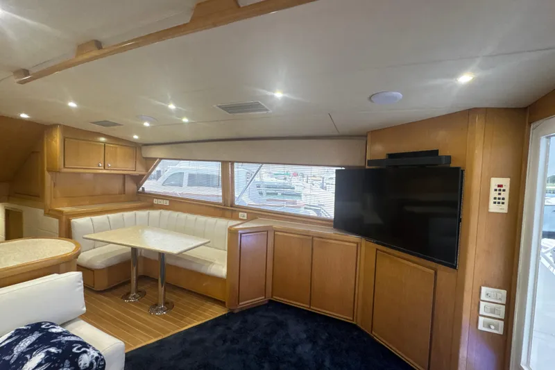 Slide: The Image of Interior of 1997 Bertram 54 Convertible yacht with dining area and TV. - 16