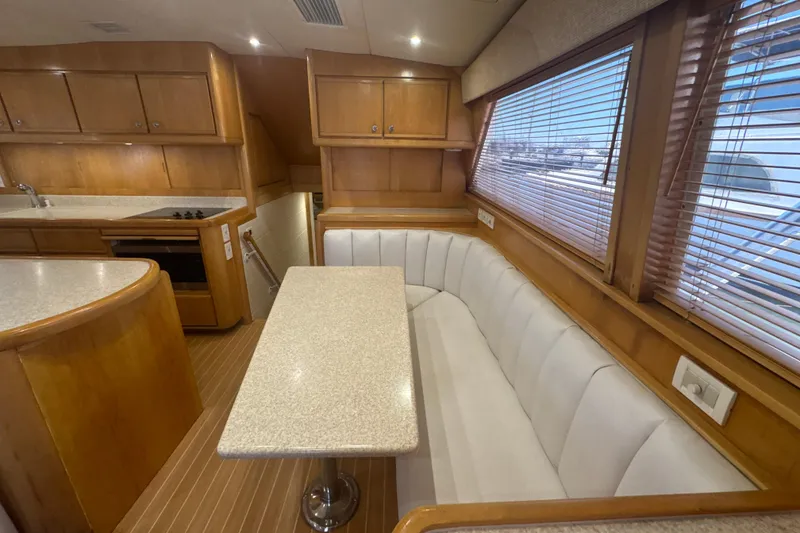 Slide: The Image of Luxurious interior of a 1997 Bertram 54 Convertible yacht with elegant wood finishes. - 17