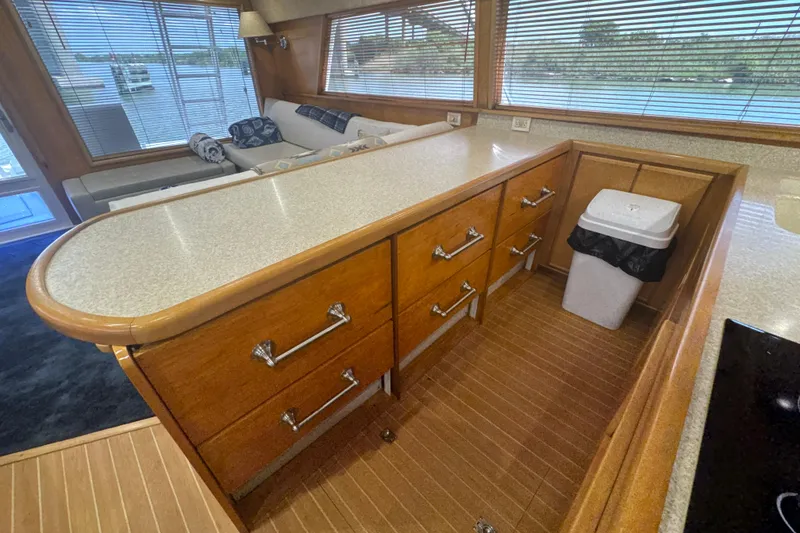 Slide: The Image of Interior of a 1997 Bertram 54 Convertible yacht with wooden cabinetry and seating area. - 18