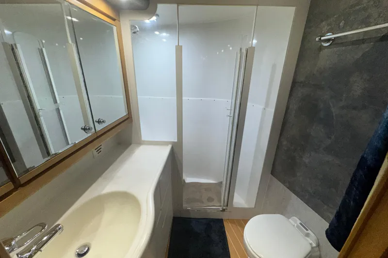 Slide: The Image of Bathroom interior of 1997 Bertram 54 Convertible yacht with shower, sink, and toilet. - 24