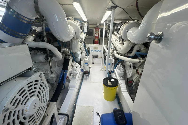 Slide: The Image of Engine room of a 1997 Bertram 54 Convertible yacht, featuring complex machinery and piping. - 28