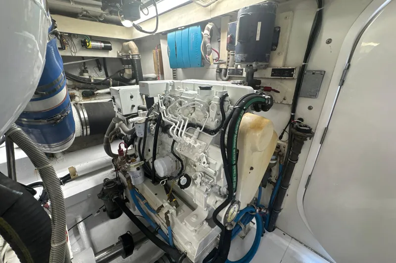 Slide: The Image of Engine room of a 1997 Bertram 54 Convertible yacht, showcasing detailed machinery. - 29