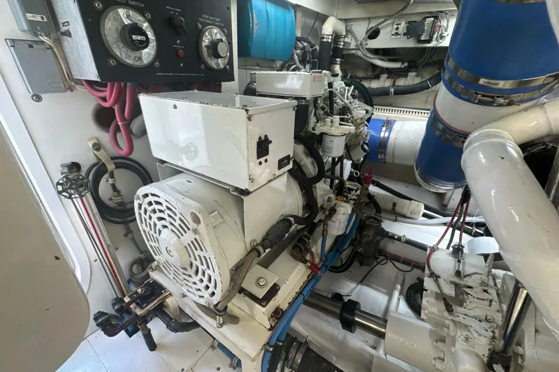 Slide: The Image of Engine room of a 1997 Bertram 54 Convertible yacht, showcasing machinery and components. - 30
