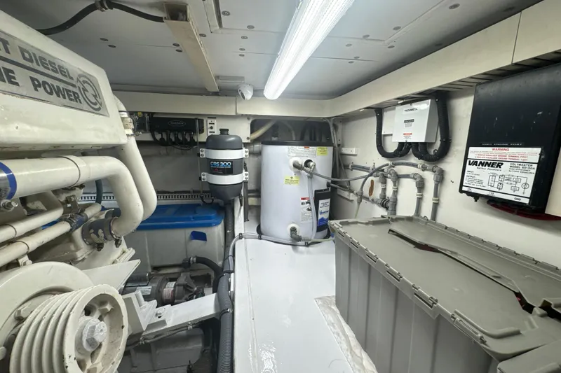 Slide: The Image of Engine room of a 1997 Bertram 54 Convertible yacht, showcasing machinery and equipment. - 32