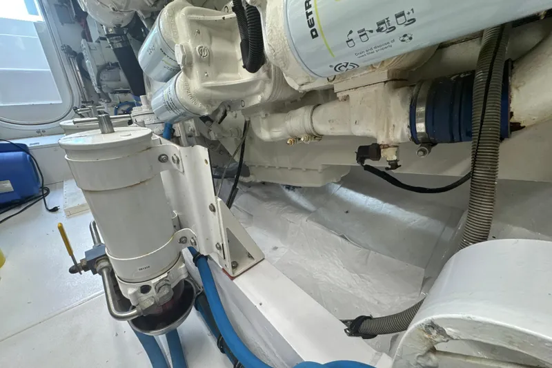 Slide: The Image of Engine room of a 1997 Bertram 54 Convertible yacht, showcasing mechanical components and filters. - 36