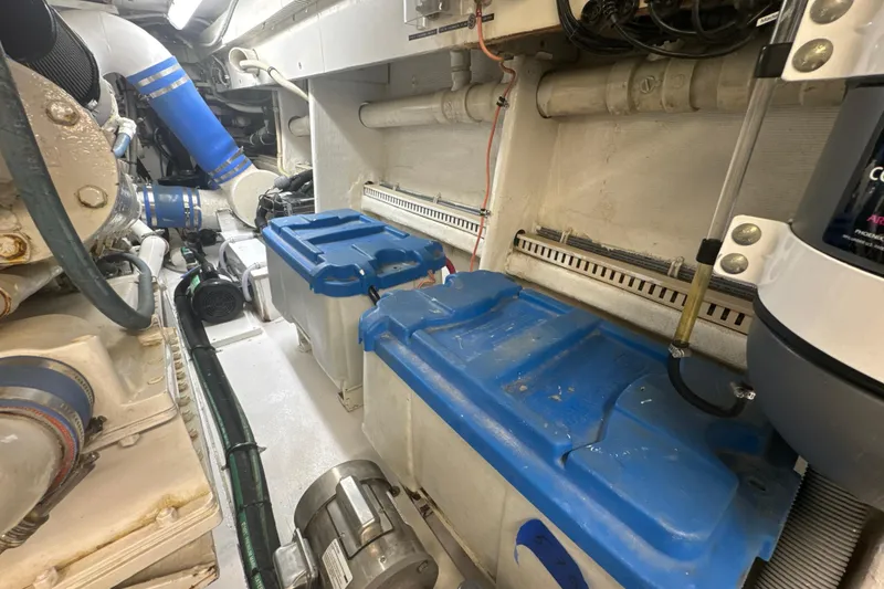 Slide: The Image of Engine room of a 1997 Bertram 54 Convertible with blue components and wiring. - 37
