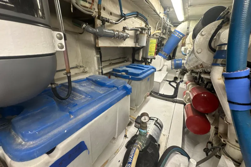 Slide: The Image of Engine room of a 1997 Bertram 54 Convertible yacht, featuring machinery and equipment. - 38
