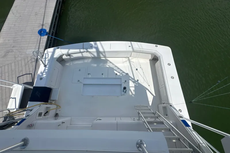 Slide: The Image of Overhead view of 1997 Bertram 54 Convertible yacht deck by the water. - 9