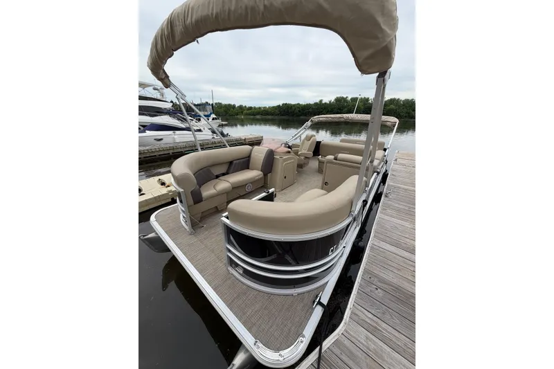 Slide: The Image of 2022 Sylvan Mirage 8522 Resorter pontoon boat docked, featuring spacious seating and canopy. - 1