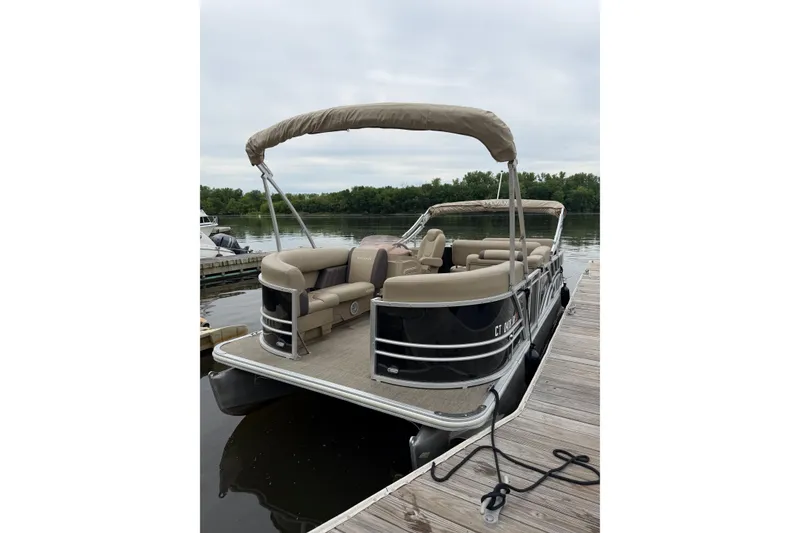 Slide: The Image of 2022 Sylvan Mirage 8522 Resorter pontoon boat docked on a calm lake. - 2