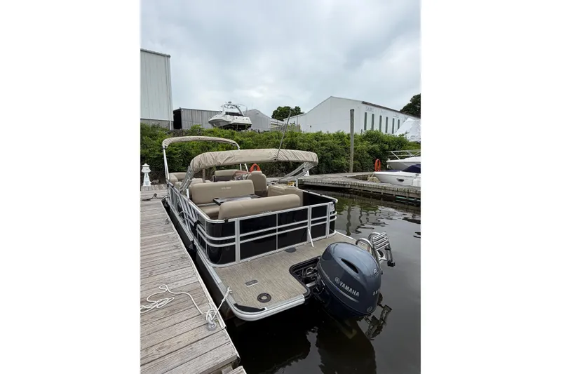 Slide: The Image of 2022 Sylvan Mirage 8522 Resorter pontoon boat docked with Yamaha outboard motor. - 3