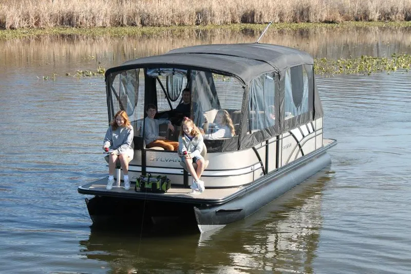 Slide: The Image of Manufacturer Provided Image: 2022 Sylvan Mirage 8522 Resorter pontoon boat on a calm lake with passengers. - 6