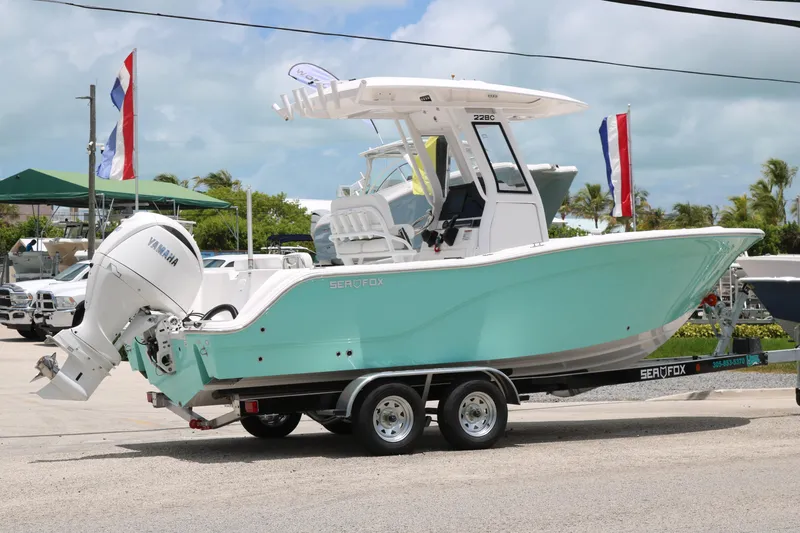 Slide: The Image of 2026 Sea Fox 228 Commander boat on trailer with Yamaha engine, outdoor display. - 1