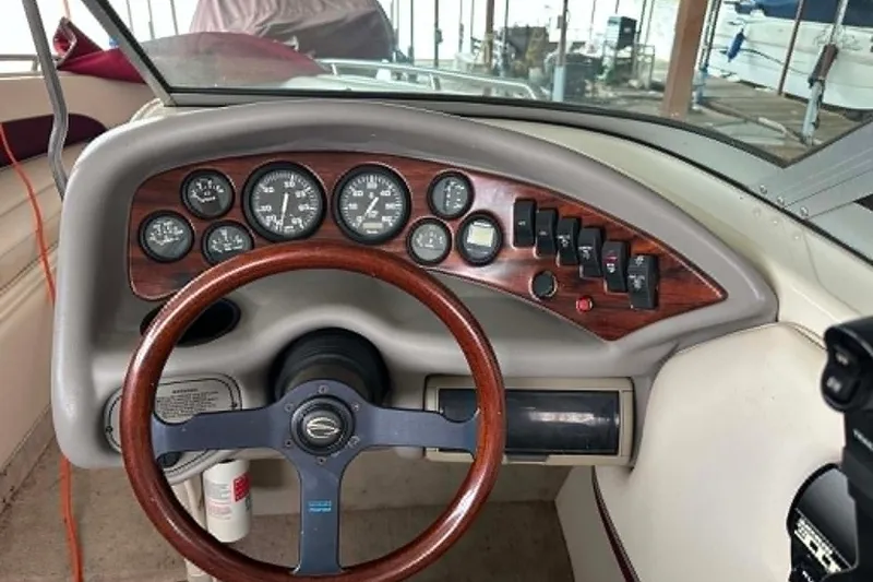 Slide: The Image of Dashboard of a 1998 Crownline 248 BR boat with wood accents and gauges. - 1