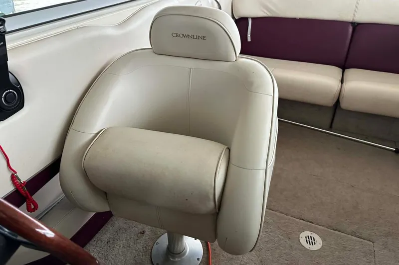 Slide: The Image of 1998 Crownline 248 BR boat interior with beige captain's chair and maroon seating. - 11