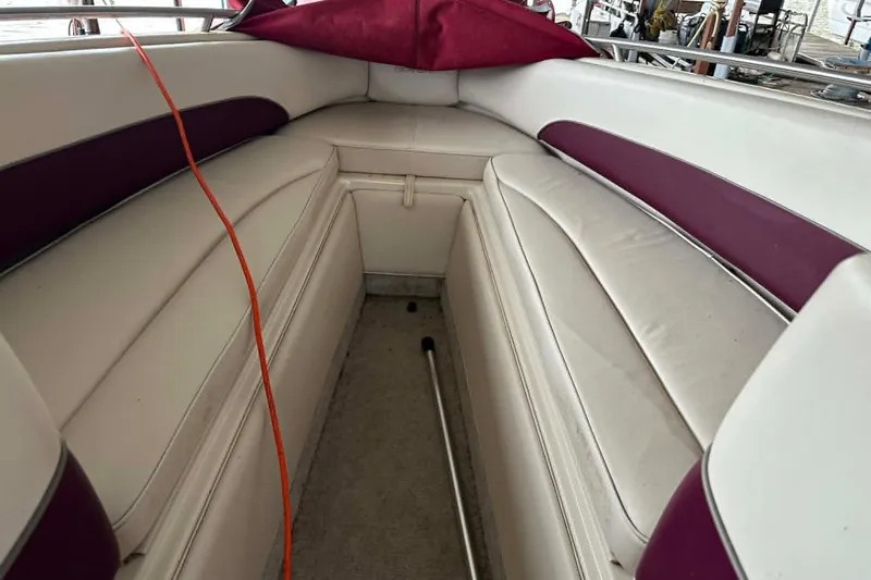 Slide: The Image of Interior of 1998 Crownline 248 BR boat with white and maroon seating. - 13