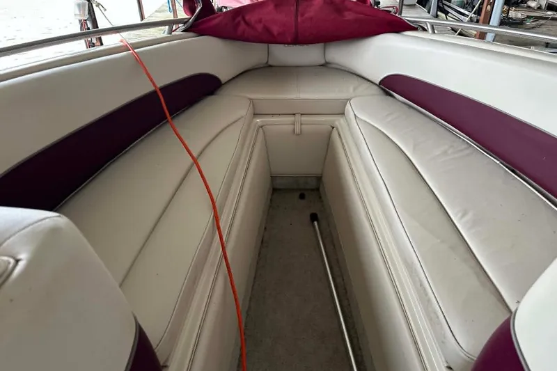Slide: The Image of Interior of a 1998 Crownline 248 BR boat with white and maroon seating. - 2