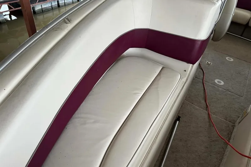 Slide: The Image of 1998 Crownline 248 BR boat interior with white and purple seating. - 3
