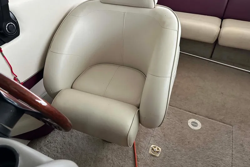 Slide: The Image of Interior of a 1998 Crownline 248 BR boat featuring a beige captain's chair. - 4