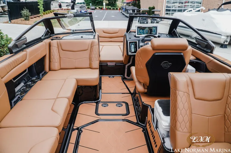 Slide: The Image of Luxurious interior of a 2021 Malibu M240 boat with tan leather seating and modern dashboard. - 10