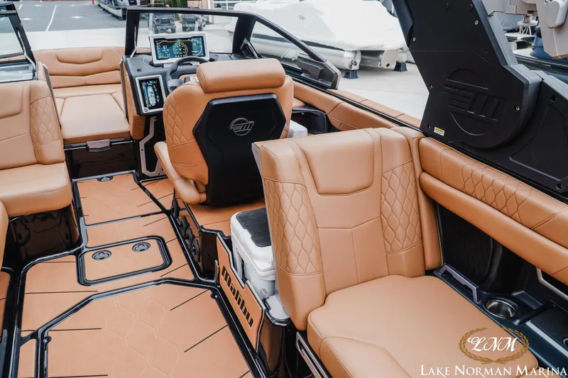 Slide: The Image of Luxurious interior of a 2021 Malibu M240 boat with tan leather seating and modern dashboard. - 11