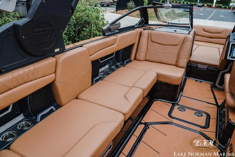 Slide: The Image of Luxurious interior of 2021 Malibu M240 boat with tan leather seating at Lake Norman Marina. - 12