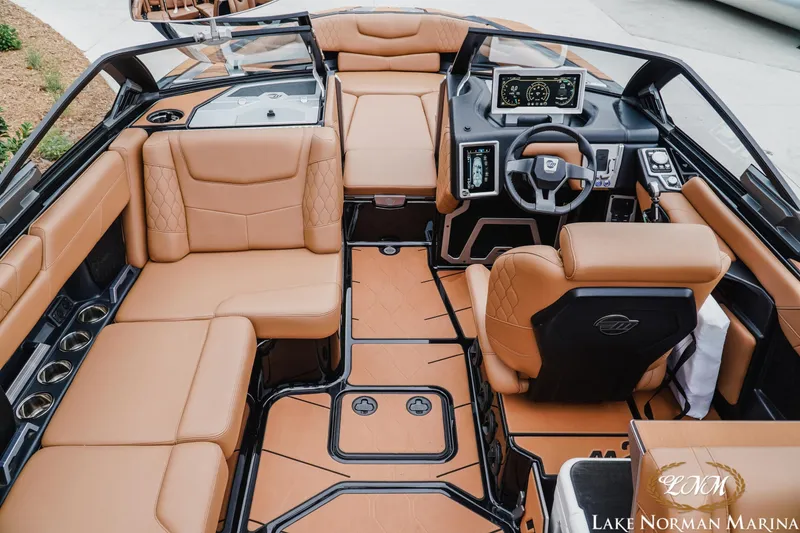 Slide: The Image of Luxurious interior of 2021 Malibu M240 boat with tan leather seating and modern dashboard. - 13