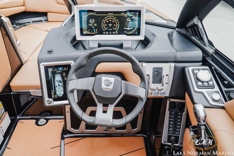 Slide: The Image of 2021 Malibu M240 boat dashboard with advanced controls and digital displays. - 16