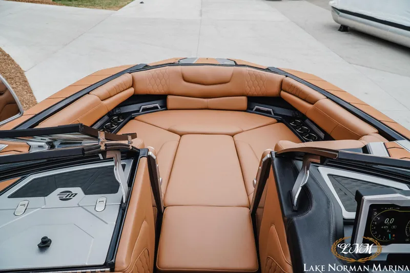 Slide: The Image of Luxurious interior of 2021 Malibu M240 boat with tan leather seating at Lake Norman Marina. - 18